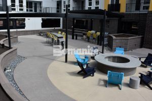 Firepit lounge area featuring Bomanite Sandscape Refined Series decorative concrete at CoLab Student Living Housing Community in Denver installed by Colorado Hardscapes using Bomanite Exposed Aggregate Systems, Bomanite Toppings Systems and Board Formed Concrete. Firepit lounge area featuring Bomanite Sandscape Refined Series decorative concrete at CoLab Student Living Housing Community in Denver installed by Colorado Hardscapes using Bomanite Exposed Aggregate Systems, Bomanite Toppings Systems and Board Formed Concrete.
