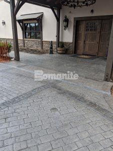 Close up view of the new Grand Entrance decorative concrete at Olde Mecklenburg Brewery in Charlotte, NC, using Bomanite Imprint Systems featuring the Running Bond Belgian Block pattern installed by Carolina Bomanite.