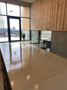 View of hallway to outside at a residence in New Hampshire featuring Bomanite Custom Polishing Systems using Bomanite Belcolore and installed by Bomanite licensee Premier Concrete Construction LLC.