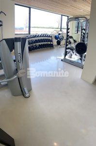 View of weight room downstairs at a residence in New Hampshire featuring Bomanite Custom Polishing Systems using Bomanite Belcolore and installed by Bomanite licensee Premier Concrete Construction LLC.