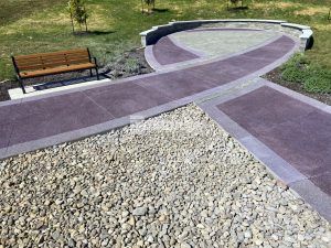 Close up of Ribbon Walk Pavilion and seating at Mosaic Life Care Cancer Center in St. Joseph, MO, featuring Bomanite Revealed decorative concrete installed by Bomanite Licensee Musselman and Hall Contractors, LLC.