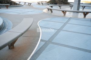 Close up view of benches, decorative concrete, fountain, and gardens at Kansas City Airport in Kansas City, MO, featuring Bomanite Sandscape Texture decorative concrete installed by Musselman & Hall Contractors.