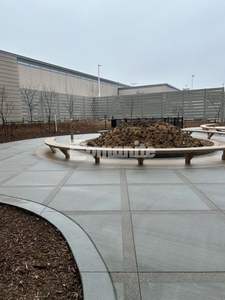 Close up towards garden at Kansas City Airport in Kansas City, MO, featuring Bomanite Sandscape Texture decorative concrete installed by Musselman & Hall Contractors.