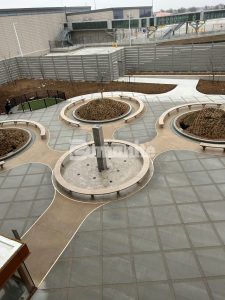 Overhead view with fountain in the center at Kansas City Airport in Kansas City, MO, featuring Bomanite Sandscape Texture decorative concrete installed by Musselman & Hall Contractors.