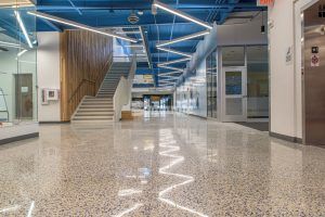 Longer view of hallway towards stairs on left at John Diemer Elementary in Overland Park, KS, featuring Bomanite Custom Polishing Systems using Bomanite Renaissance installed by Bomanite Licensee Musselman and Hall Contractors, LLC.